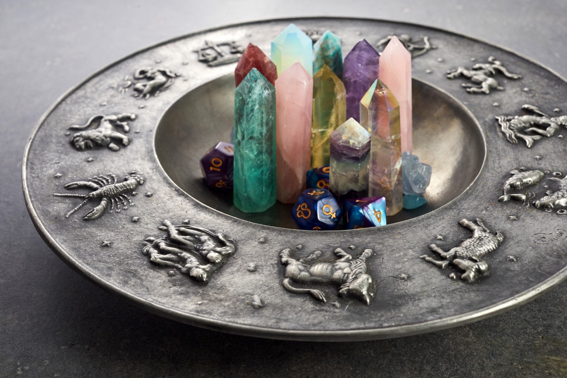 Crystals for healing, fortune telling and astrologhy circle on grey background. Esoteric and life coaching concept.